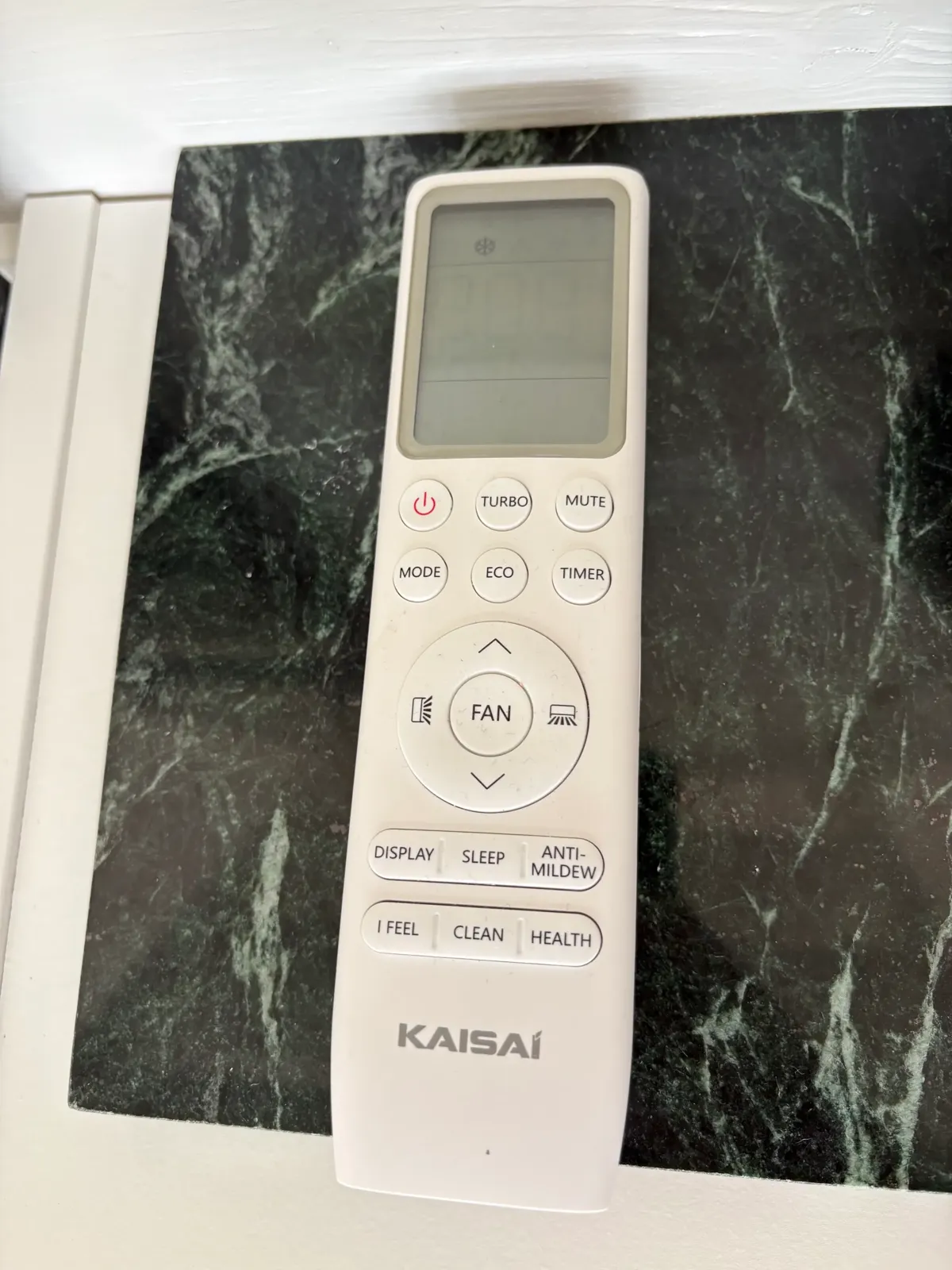 Air-conditioner remote with its power button at the upper left.