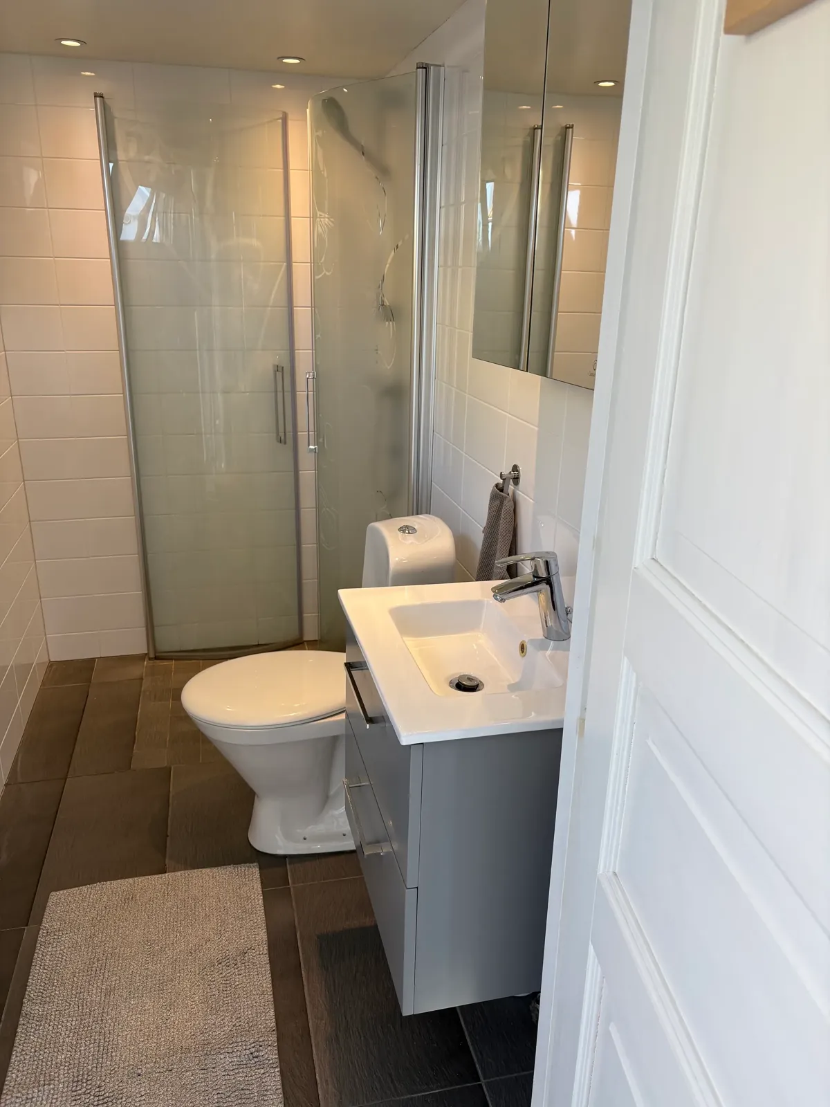 Compact private bathroom with shower