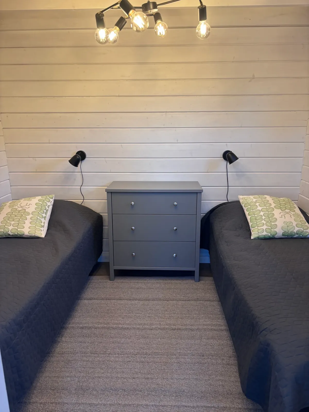 Twin bedroom with grey linens